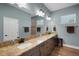 Bathroom featuring a large mirror and vanity with a granite countertop at 1 Brogden Se Ct, Winter Haven, FL 33880