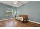 Bedroom with wood flooring and window providing natural light at 1 Brogden Se Ct, Winter Haven, FL 33880