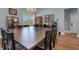 Spacious dining room with a large wooden table, seating for twelve, a chandelier, and built-in storage at 1 Brogden Se Ct, Winter Haven, FL 33880
