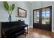 Bright foyer showcasing a piano, wood floors, and an entryway with double doors that opens to the front yard at 1 Brogden Se Ct, Winter Haven, FL 33880
