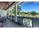Inviting front porch with rocking chairs offering tranquil views of the lush greenery and landscaping at 1 Brogden Se Ct, Winter Haven, FL 33880