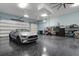 Spacious garage with epoxy flooring, storage, and car, offering plenty of room for parking and hobbies at 1 Brogden Se Ct, Winter Haven, FL 33880