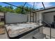 Inviting hot tub in screened enclosure with seating, creating a private backyard retreat at 1 Brogden Se Ct, Winter Haven, FL 33880