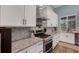 Gourmet kitchen features stainless steel appliances and white cabinets at 1 Brogden Se Ct, Winter Haven, FL 33880