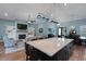 Modern kitchen with a spacious island, elegant pendant lighting, and an open layout that connects to the living area at 1 Brogden Se Ct, Winter Haven, FL 33880