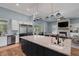 Gourmet kitchen features an island with granite countertops and stainless steel appliances at 1 Brogden Se Ct, Winter Haven, FL 33880