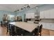 Large kitchen with an island that features barstool seating, granite countertops, and stainless steel appliances at 1 Brogden Se Ct, Winter Haven, FL 33880