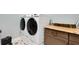 Updated laundry room featuring dual front-load washer and dryer on pedestals and granite countertops at 1 Brogden Se Ct, Winter Haven, FL 33880