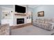 Cozy living room with fireplace, built-in bookshelves, and comfortable seating, creating a relaxing ambiance at 1 Brogden Se Ct, Winter Haven, FL 33880