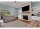 Comfortable living room featuring a decorative fireplace, a TV, built-in shelves, and sliding glass doors at 1 Brogden Se Ct, Winter Haven, FL 33880