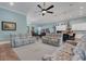 Inviting living space with a ceiling fan, two reclining sofas, and views of the kitchen and dining areas at 1 Brogden Se Ct, Winter Haven, FL 33880
