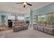 Open living space featuring the kitchen, with stainless steel appliances, and comfortable seating with clear outdoor access at 1 Brogden Se Ct, Winter Haven, FL 33880