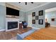 Charming main bedroom offers a fireplace, television, and a decorative bench at 1 Brogden Se Ct, Winter Haven, FL 33880