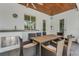 Covered outdoor dining area with an outdoor sink and seating for six at 1 Brogden Se Ct, Winter Haven, FL 33880