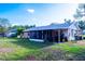 Expansive backyard featuring a screened-in porch, carport, and ample green space at 1160 Eleanore Ave, Bartow, FL 33830