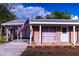 Charming brick home with a cozy carport and well-maintained landscaping and decorative touches at 1160 Eleanore Ave, Bartow, FL 33830