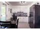 Modern kitchen featuring sleek white cabinets, stainless steel appliances, and sliding glass doors at 1160 Eleanore Ave, Bartow, FL 33830