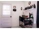Kitchenette area featuring a side entry door, shelving, table, and chair at 1160 Eleanore Ave, Bartow, FL 33830
