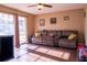 The expansive living room has wood flooring and a ceiling fan at 1160 Eleanore Ave, Bartow, FL 33830