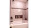 Brightly tiled tub-shower combo has recessed niche at 1160 Eleanore Ave, Bartow, FL 33830