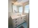 Bathroom featuring a white vanity with bronze pulls and blue floor tiles at 1208 W Lake Buckeye Dr, Winter Haven, FL 33881