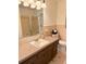 Bathroom featuring pink and beige tile, a shower, and a brown vanity at 1208 W Lake Buckeye Dr, Winter Haven, FL 33881