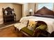 Bedroom with a four poster bed, settee, and hardwood floors at 1208 W Lake Buckeye Dr, Winter Haven, FL 33881