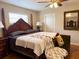 Comfortable bedroom with a four poster bed, hardwood floors, and a dark wood mirror at 1208 W Lake Buckeye Dr, Winter Haven, FL 33881