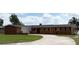 Charming single-story home featuring a brick and siding exterior, well-manicured lawn, and a spacious driveway at 1208 W Lake Buckeye Dr, Winter Haven, FL 33881