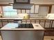 Large kitchen with island cooktop, stainless steel appliances, and tile backsplash at 1208 W Lake Buckeye Dr, Winter Haven, FL 33881