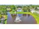 Community pool and fountain with rainbow reflection, surrounded by lush greenery and recreational facilities at 1215 Evergreen Park Cir, Lakeland, FL 33813