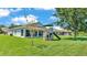 Scenic view of the backyard with a playset and screened patio, offering a great outdoor space at 1215 Evergreen Park Cir, Lakeland, FL 33813
