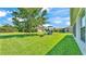 Spacious backyard features lush green grass and a playset, perfect for outdoor activities at 1215 Evergreen Park Cir, Lakeland, FL 33813