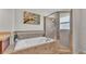 Elegant bathroom with a large soaking tub and a separate glass-enclosed shower at 1215 Evergreen Park Cir, Lakeland, FL 33813