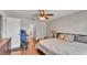 Comfortable bedroom with hardwood floors, accent wall, and bright ceiling fan at 1215 Evergreen Park Cir, Lakeland, FL 33813