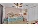 Colorful bedroom featuring a ceiling fan, soft carpet, and a bright blue comforter at 1215 Evergreen Park Cir, Lakeland, FL 33813