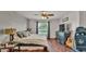 Charming bedroom with hardwood floors, accent wall, and natural light from the window at 1215 Evergreen Park Cir, Lakeland, FL 33813