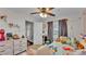 Bright bedroom featuring a ceiling fan, plush bedding and ample natural light through the window at 1215 Evergreen Park Cir, Lakeland, FL 33813