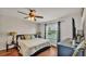 Cozy bedroom with hardwood floors, accent wall, and natural light from the window at 1215 Evergreen Park Cir, Lakeland, FL 33813