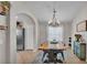 Dining area featuring a modern chandelier, and stainless steel appliances in the background at 1215 Evergreen Park Cir, Lakeland, FL 33813