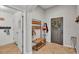 Inviting entryway with a coat rack, bench, and tile flooring at 1215 Evergreen Park Cir, Lakeland, FL 33813