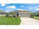 Charming single-story home with a well-manicured lawn and an attached two-car garage at 1215 Evergreen Park Cir, Lakeland, FL 33813