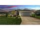 Charming single-story home with a well-manicured lawn, two-car garage, and inviting front entrance at 1215 Evergreen Park Cir, Lakeland, FL 33813