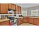 Cozy kitchen with warm wood cabinets and ample counter space at 1215 Evergreen Park Cir, Lakeland, FL 33813