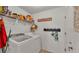Efficient laundry room with modern washer and dryer, storage shelves, and practical design at 1215 Evergreen Park Cir, Lakeland, FL 33813