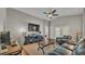 Comfortable living room featuring high ceilings, hardwood floors, and a leather sofa at 1215 Evergreen Park Cir, Lakeland, FL 33813
