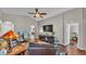 Open-concept living room with hardwood floors, vaulted ceilings, and comfortable leather seating at 1215 Evergreen Park Cir, Lakeland, FL 33813
