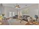Spacious living room with hardwood floors, leather furniture, and a ceiling fan at 1215 Evergreen Park Cir, Lakeland, FL 33813