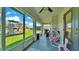 Relaxing screened patio with comfortable seating and views of the backyard and playground at 1215 Evergreen Park Cir, Lakeland, FL 33813