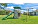 playset with slide and swings in a large, well-kept lawn at 1215 Evergreen Park Cir, Lakeland, FL 33813